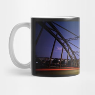 Perspective of an iron bridge with car light trails at twilight in Berlin, Germany Mug